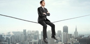 businessman sitting on rope and city